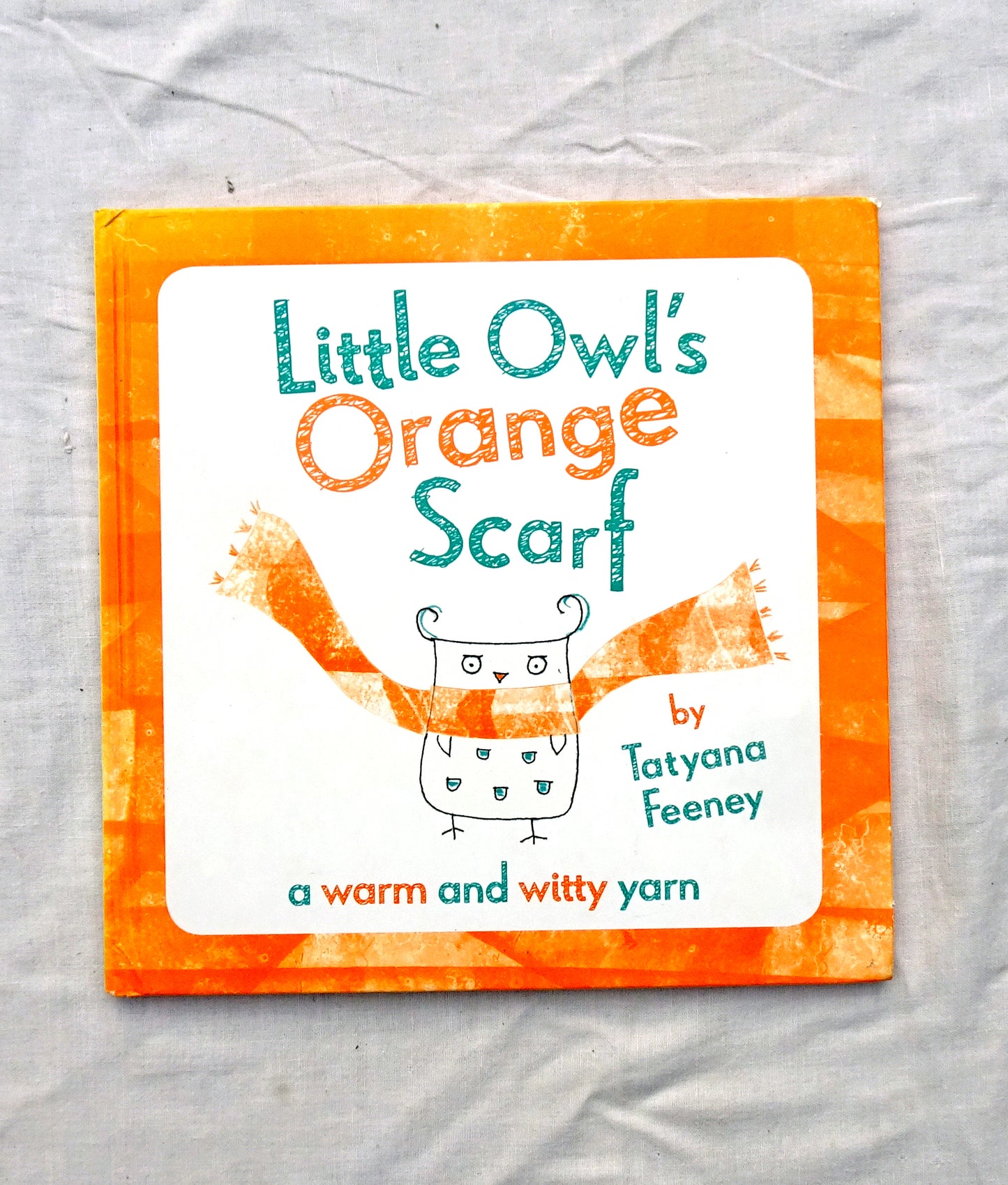 Little owl's orange scarf